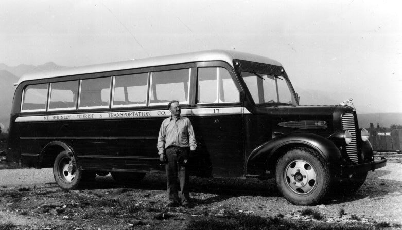 man standing by a bus