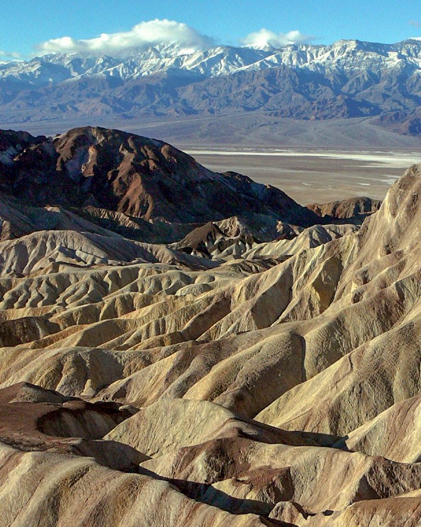 overlook of badlands, valley, and distant peaks