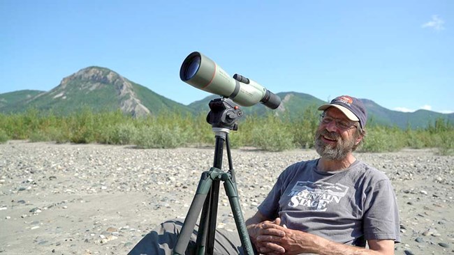 Dave Payer A researcher observing birds through spotting scope.