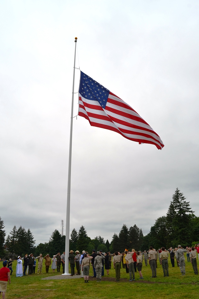 Troops and volunteers raise the garrison flag
