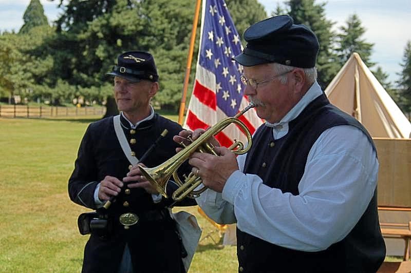 Photo of two men in Civil War era costume playing instruments