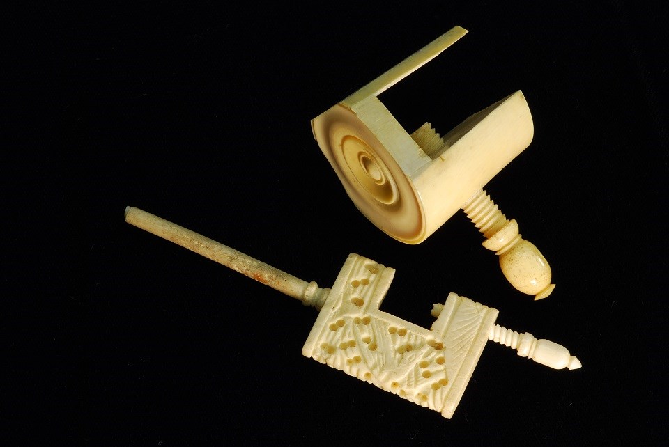 Photo of two ivory sewing tools with ivory screws.