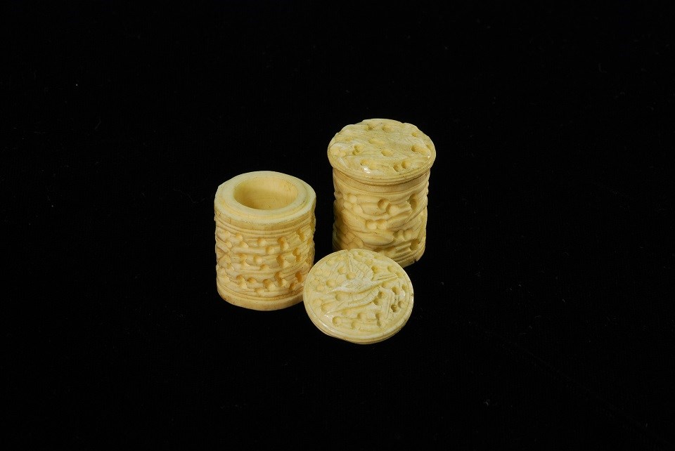 Two carved bone containers.