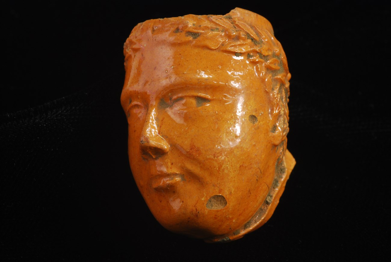 Photo of red clay tobacco pipe bowl molded in the figure of the head of Millard Fillmore