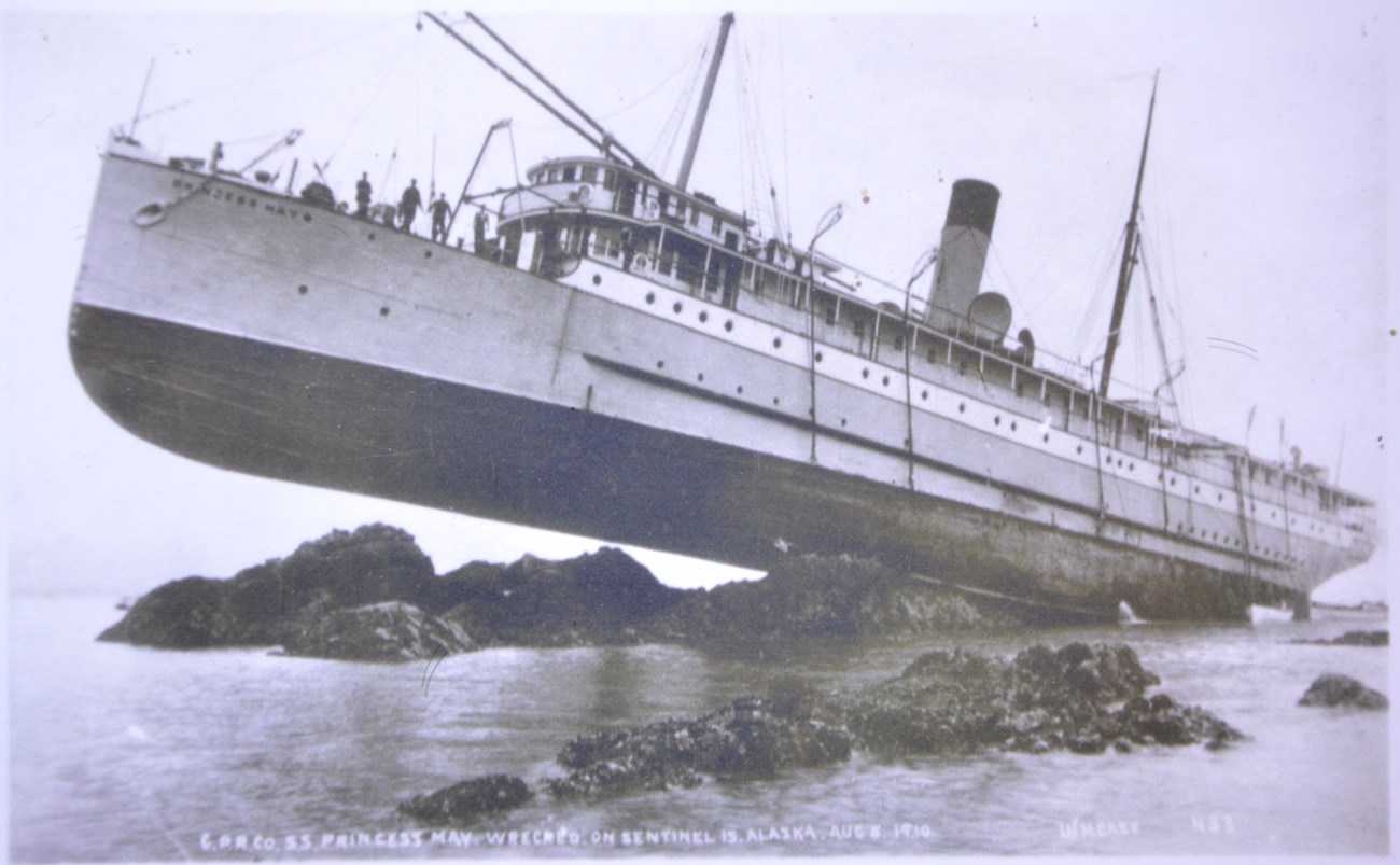 Steamship run aground on jutting rocks