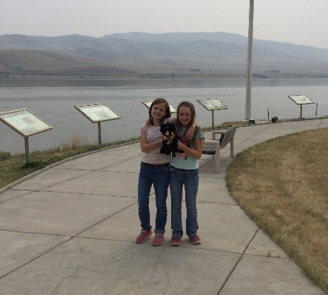 two girls holding toy dog