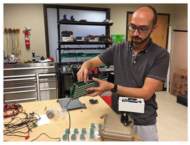 NPS physical scientist Damon Joyce shows some of the electronic components that comprise the noise level display signs.