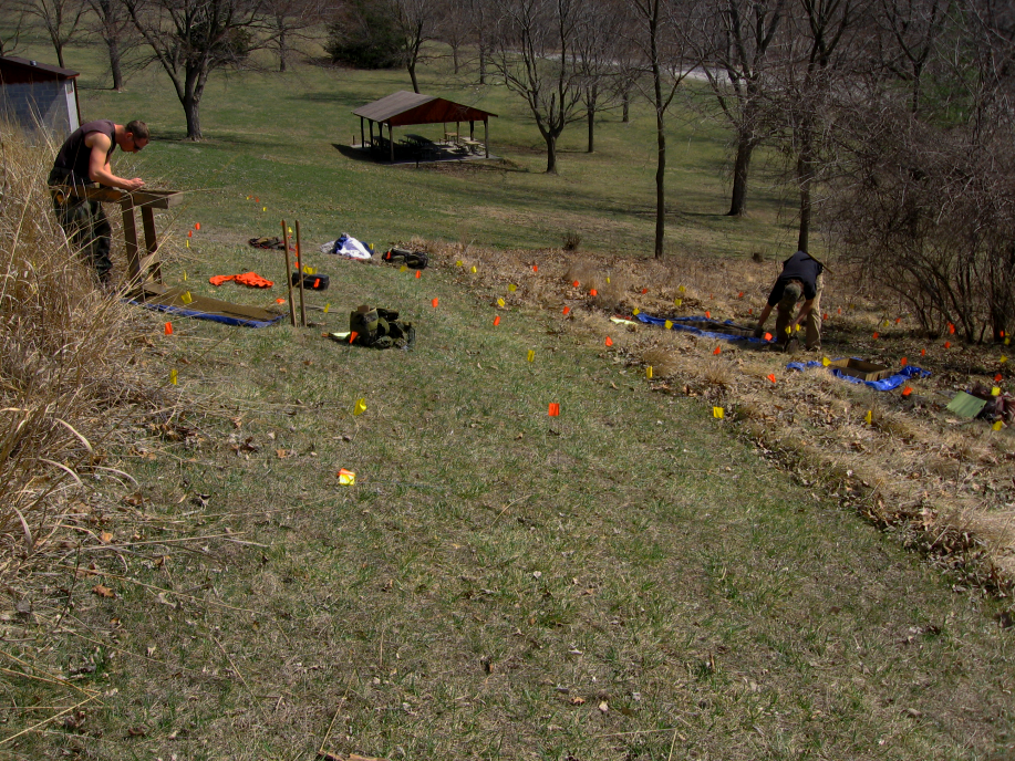 Davis Oriole Earthlodge Site People marking a field with colorful flags.