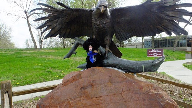 Stuffed pup near eagle statue