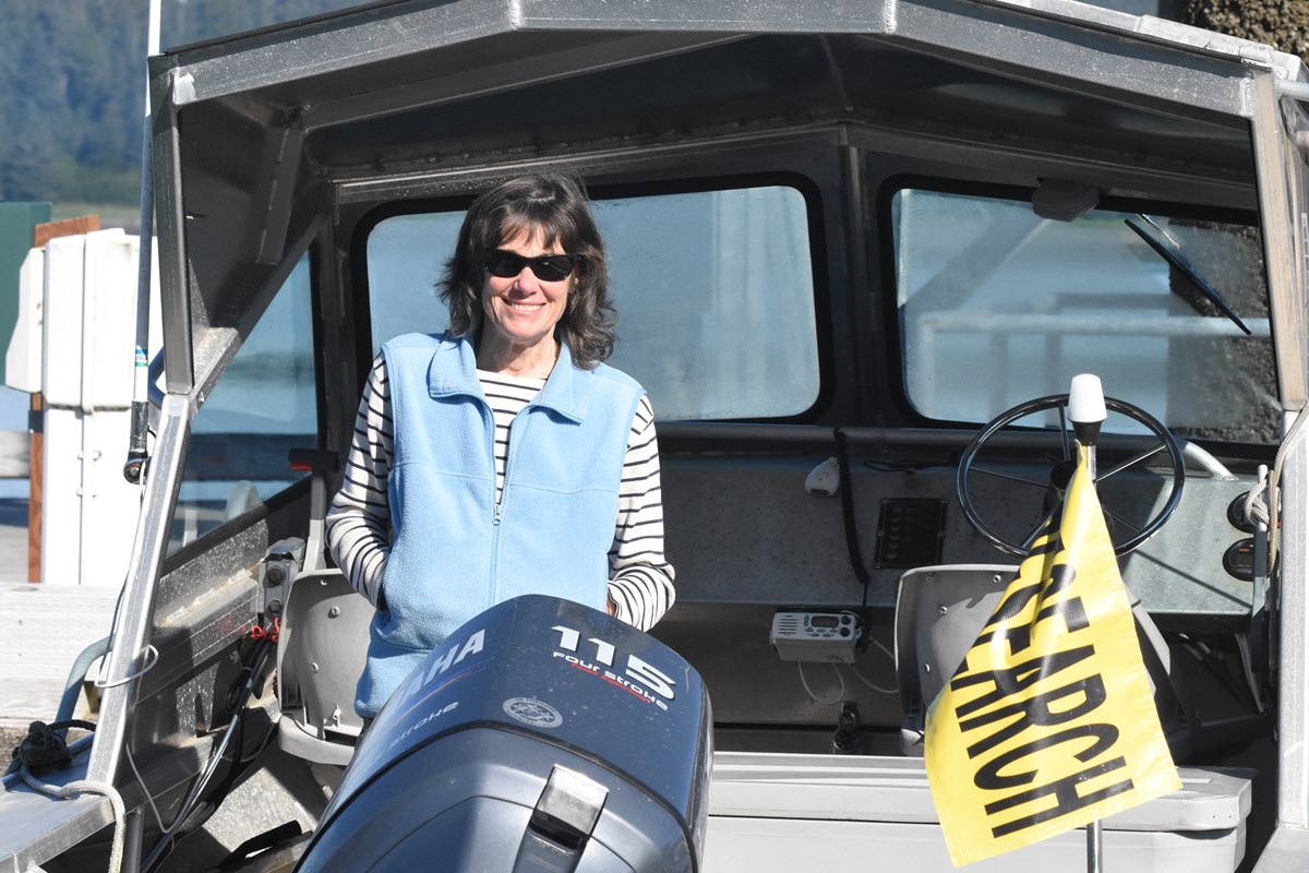 Orca researcher Dena Matkin stands on research vessel