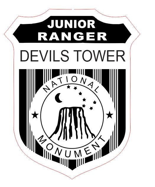 Devils Tower Junior Ranger Badge graphic. Text on graphic reads: Junior Ranger Devils Tower National Monument. Graphic has image of Devils Tower with crescent moon and stars.
