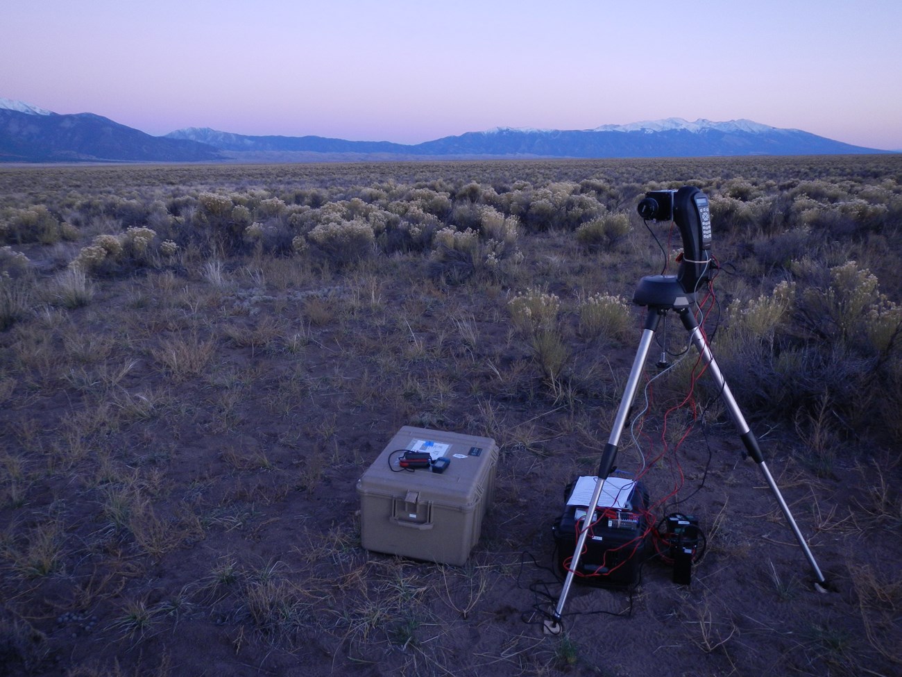 The CCD camera captures night sky conditions in a variety of locations, from grasslands and coasts to mountains and deserts. The night sky CCD camera is installed in a high desert prairie location with snow-capped mountains beyond.