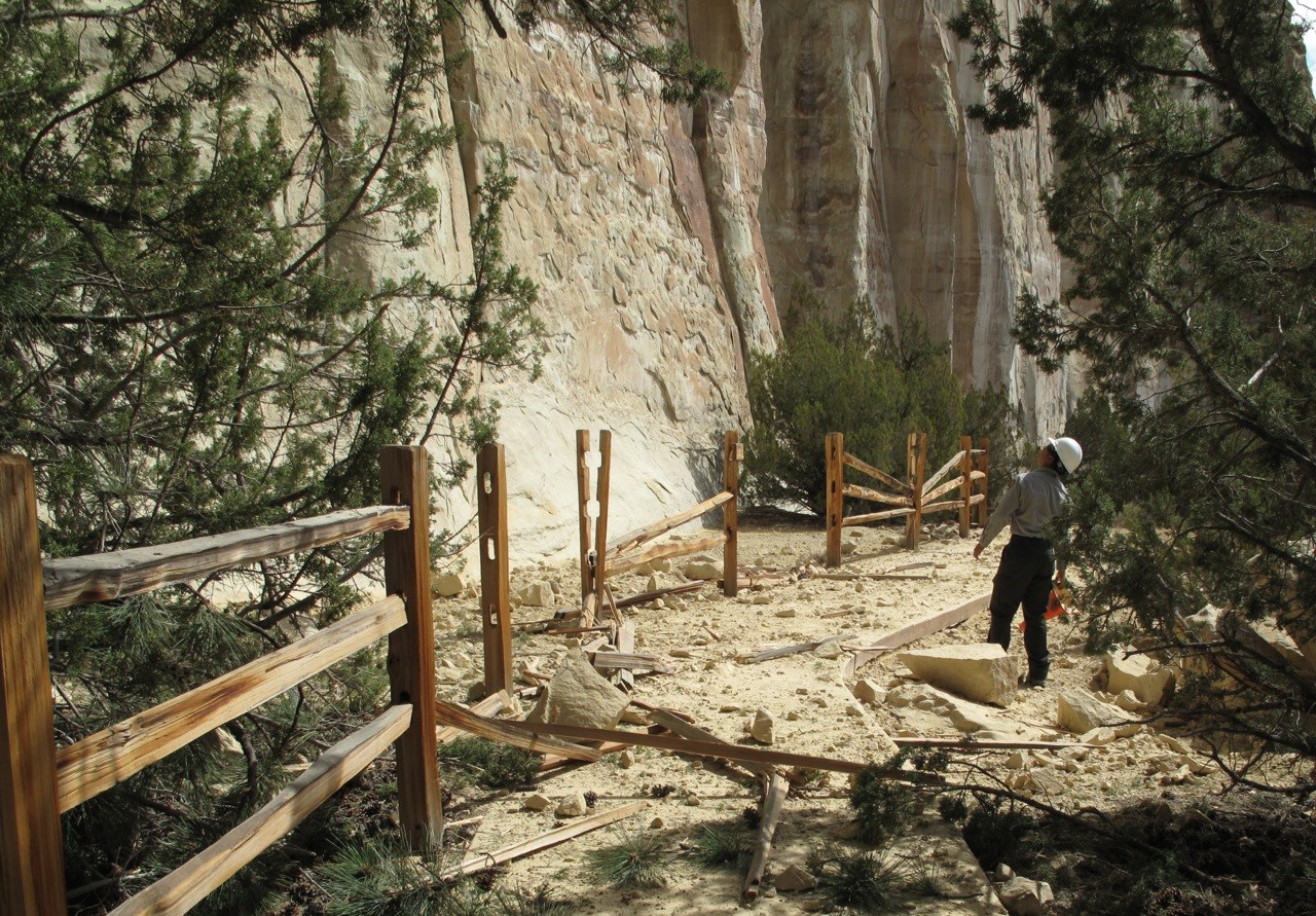 ELMO 2013 rockfall NPS photo Photo of a trail with a broken fence and rock debris