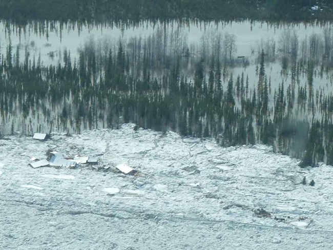 Eagle Village_web A village is smothered in large ice floes as the river breaks up.