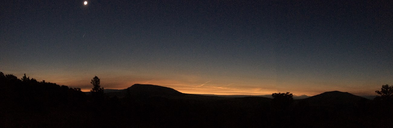 Crooked River Eclipse Panorama shows sunset effect during the eclipse at Crooked River National Grassland.