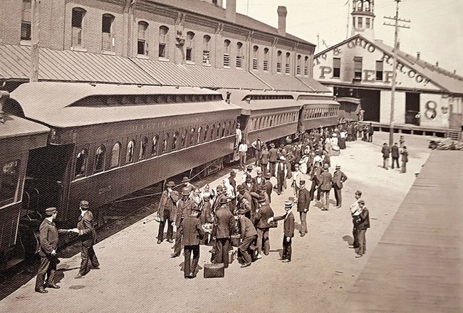 People stand in front of a train.