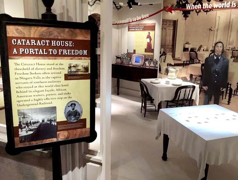 Cataract House Hotel exhibit with tables, silverware, illustrations, and panel text.