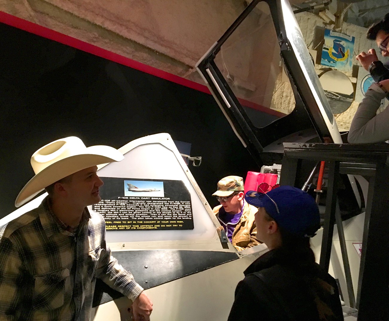 Students look at a model plane. Students look at a model plane.