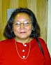Eleanor C. Johnson, President and CEO of Kijik Corp, Anchorage Picture of Eleanor Johnson in red shirt carrying a purse.
