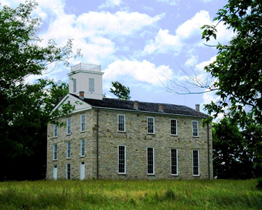Eleutherian College NHL Stone building with a black and white roof.