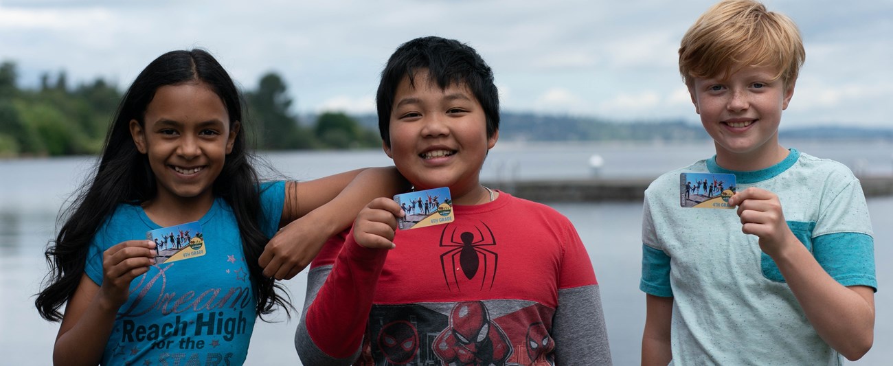 Every Kid Outoors Courtesy of Auriza Ugalino Three kids holding Every Kid Outdoors passes