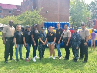 Men and women outside, posing with park police.