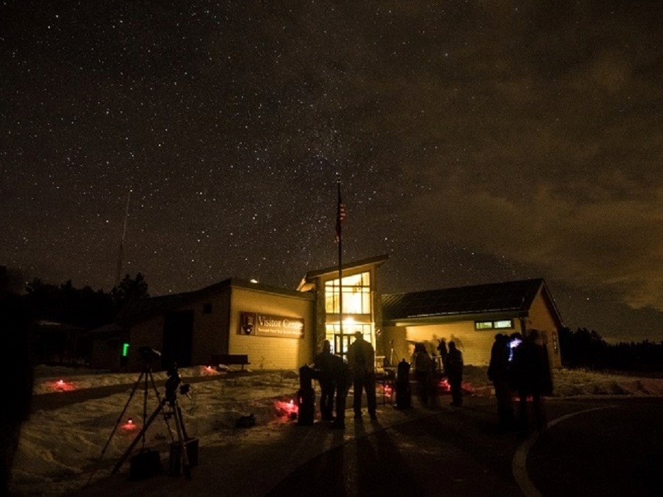 Star party outside a visitor center at night
