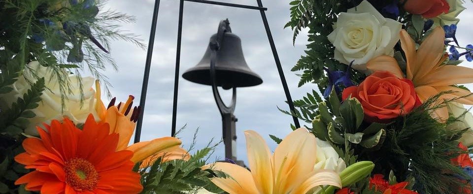 FOMR Bell Flowers in front of a hanging bell