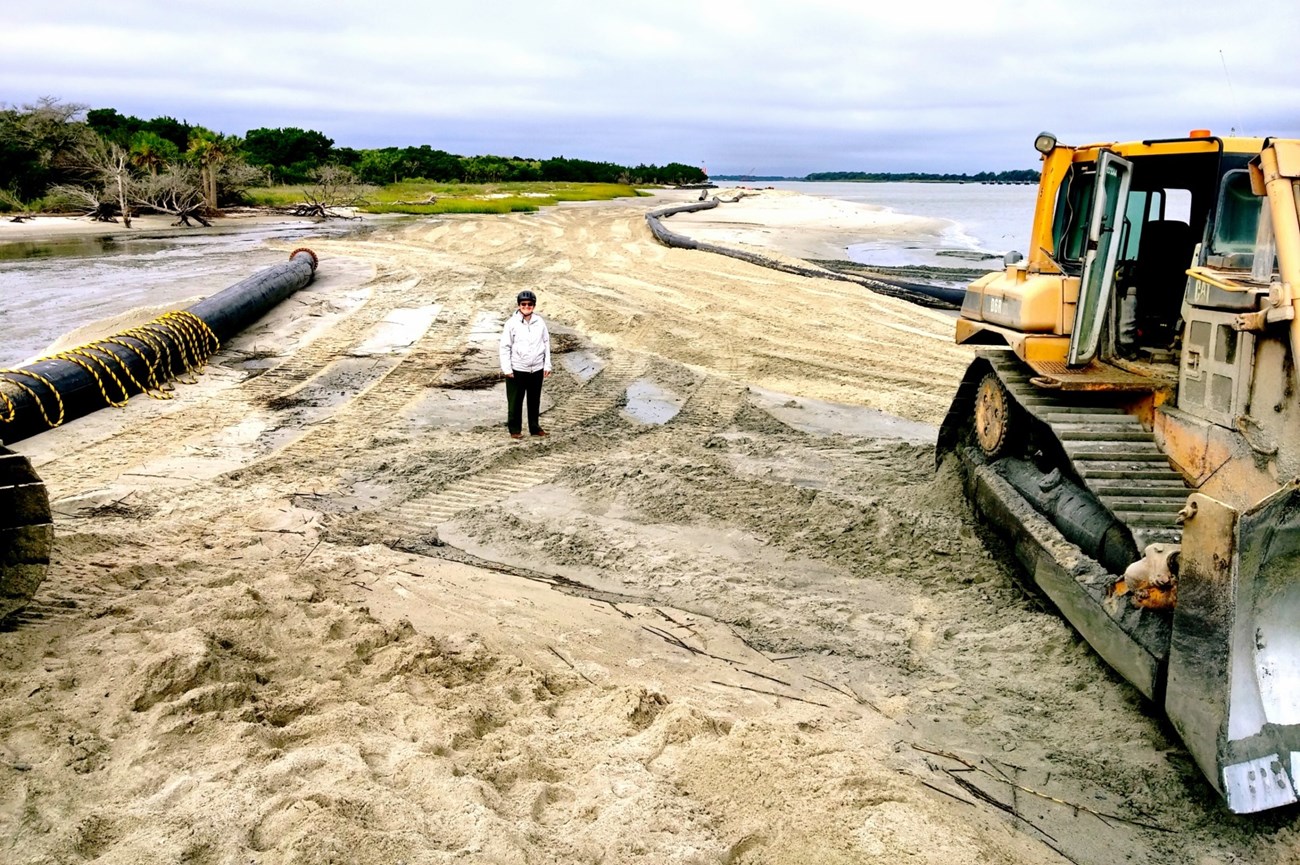 heavy equipment adding sand to the beach