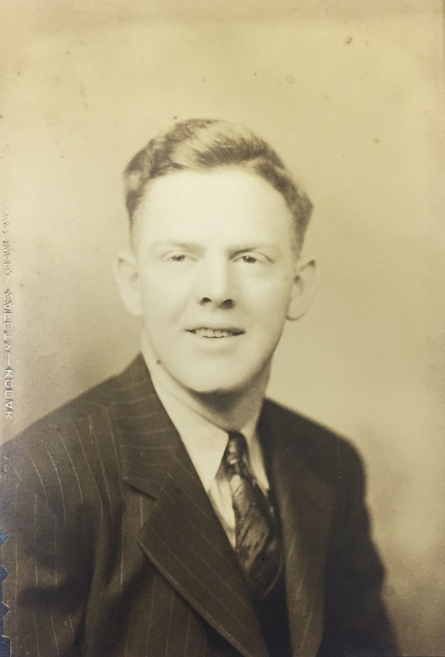 Black and white photo of a man in a suit.