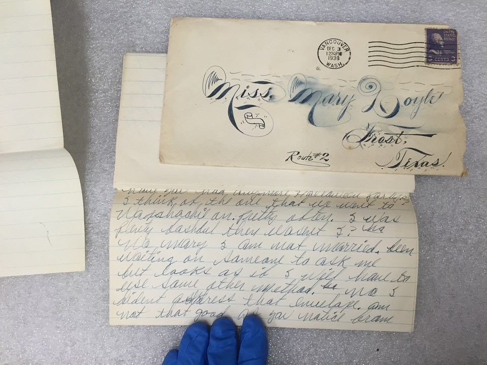 Photo of envelope addressed to Miss Mary Doyle, Frost, Texas, alongside a handwritten letter.