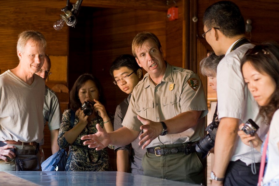 FRLA Ranger Giving Tour Ranger giving a talk to visitors over a tabletop display