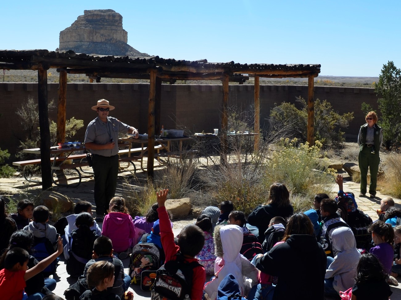 school group attends a ranger talk outdoors