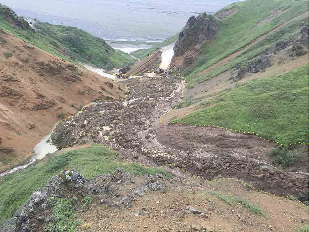 A landslide snakes down the hillside.