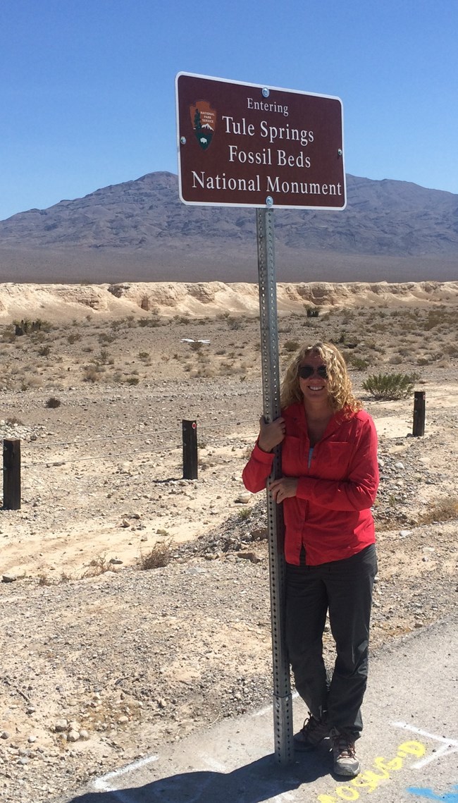 geologist standing by park sign