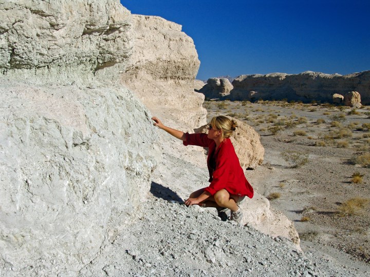 researcher examining a large rock