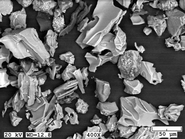 Magnified ash particles, volcanic glass shards.