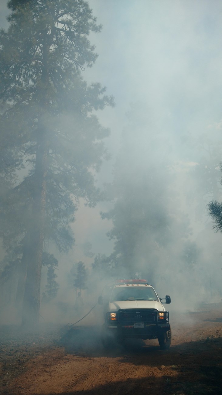 Fire engine drives though smoke Fire engine drives though smoke