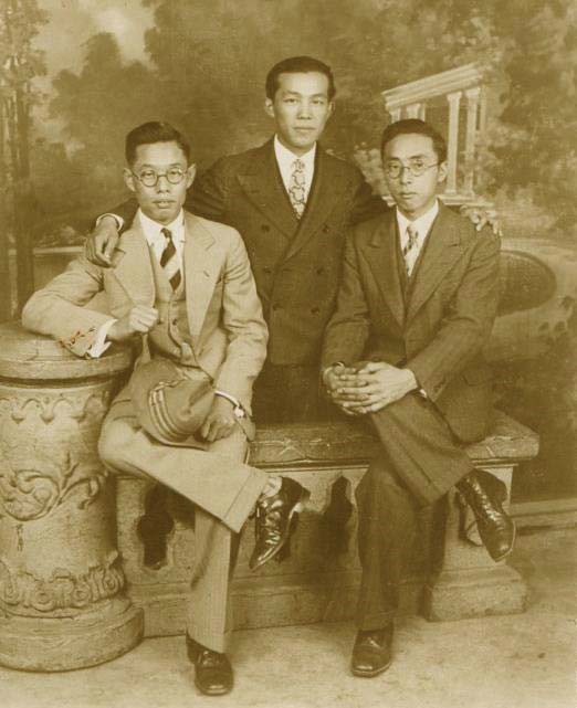 Three men pose for a picture