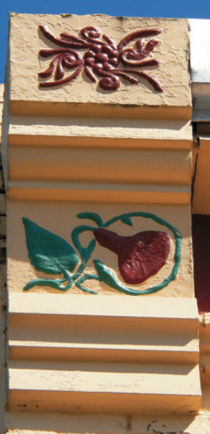 Flour-de-lis motif Green and red designs on wood.