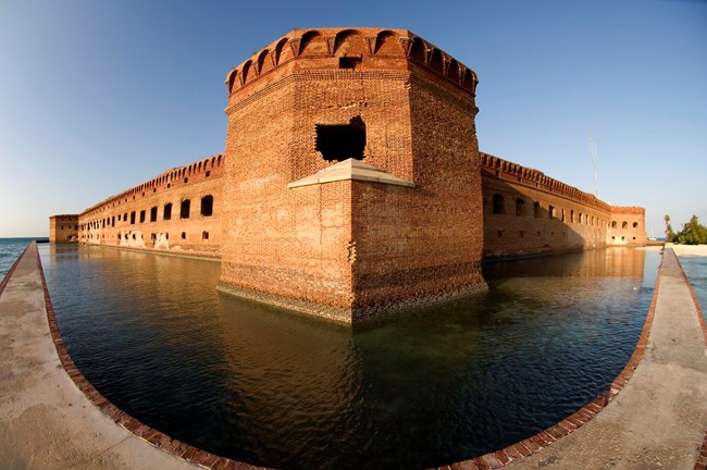 A brick structure with water surrounding the walls