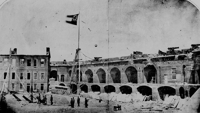 Interior shot from parade ground of Fort Sumter after the evacuation of Major Anderson's Union garrison. First National Confederate flag flying over fort.