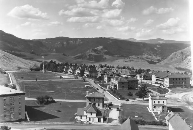 fort with parade grounds and mountains in background