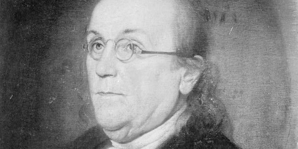 Detail, black and white print of Benjamin Franklin wearing spectacles.