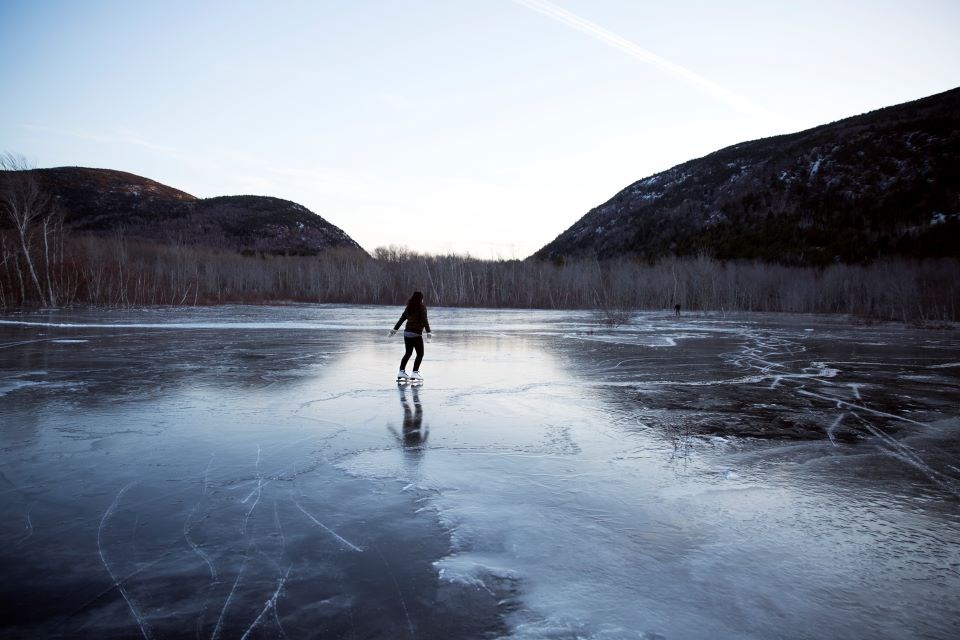Frozen Meadow a person ice skating on ice covered meadow
