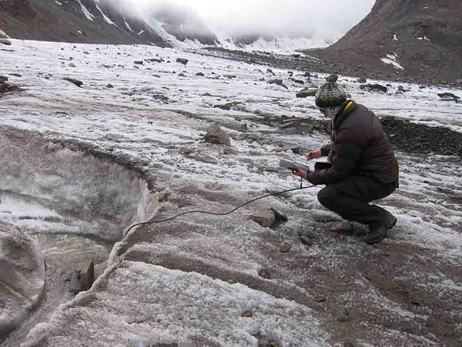 GAAR snowfields_ChrisCiancibelli_web A researcher takes measurements at a snowfield high in the Brooks Range.