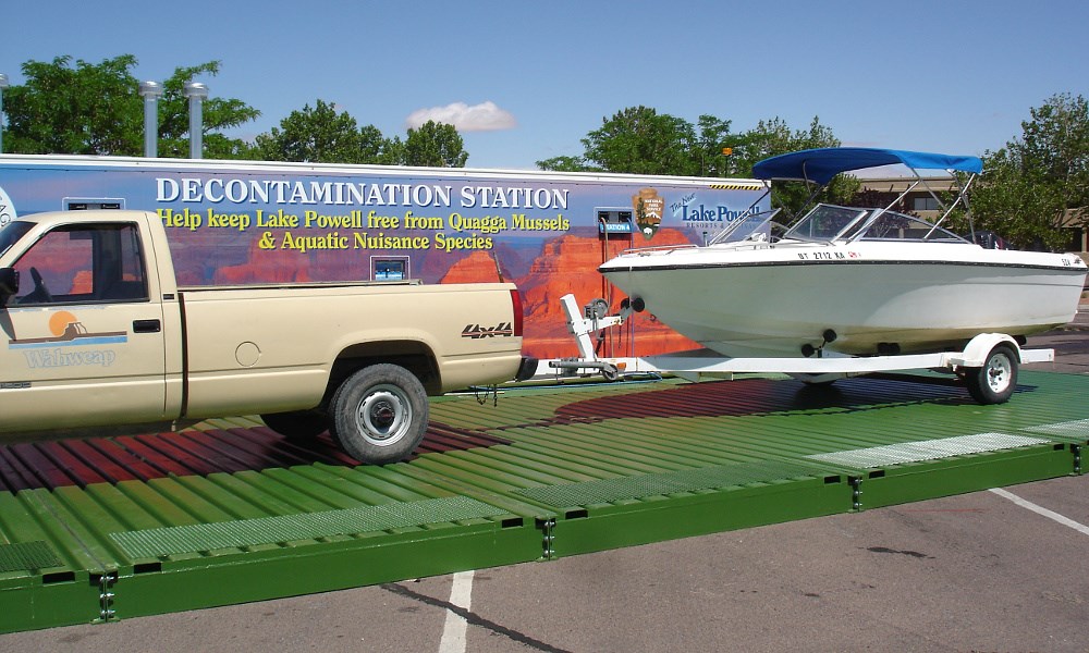 Pick-up truck towing boat at mussel decontamination station