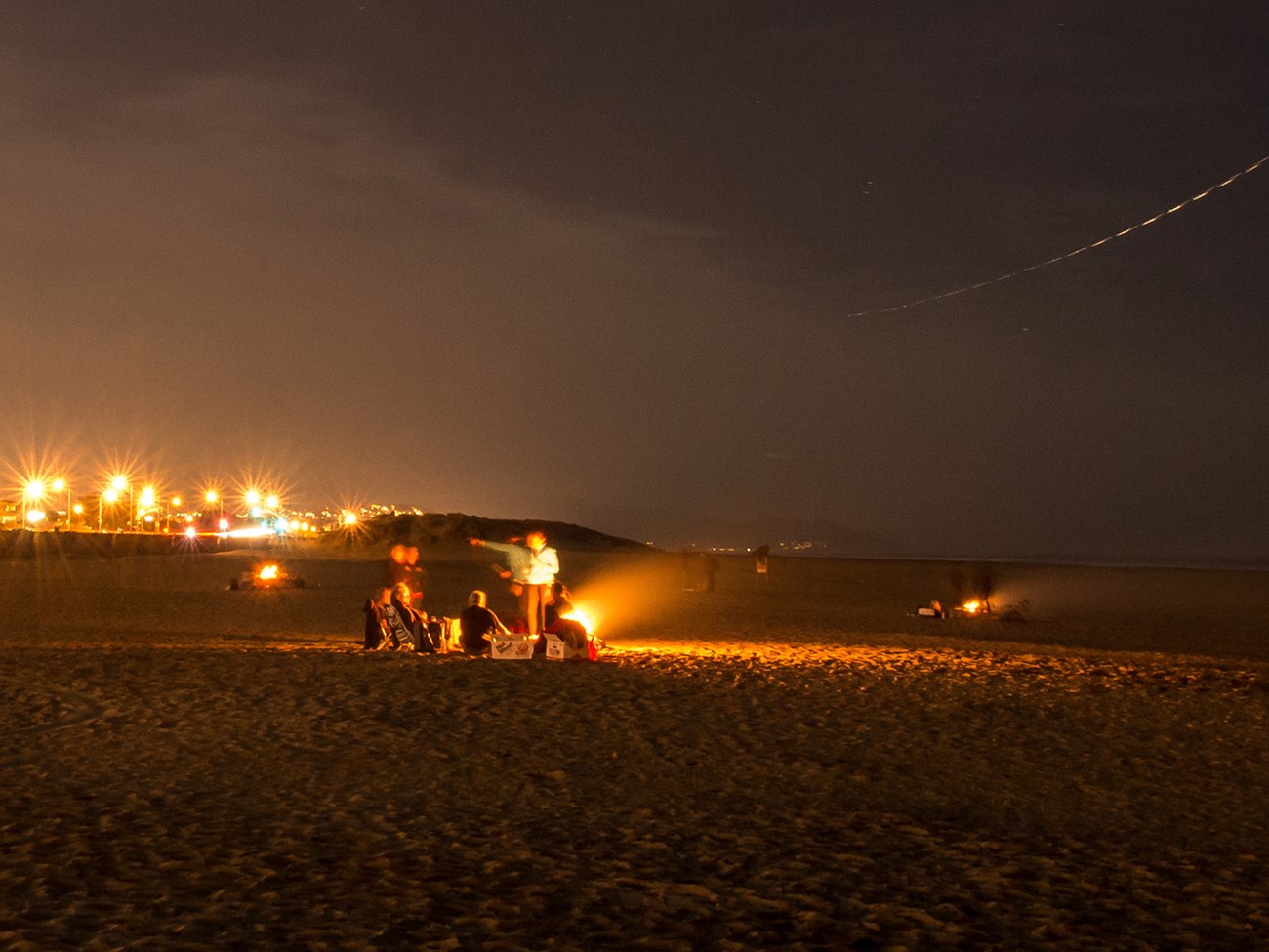 Night time at Ocean Beach with scattered beach fires on sand