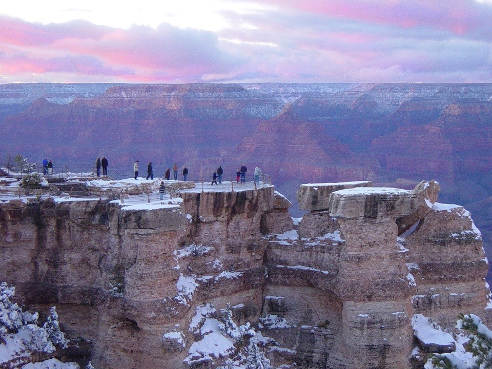 GRCA-Winter Sunset Visitors at Mather People stand on snowy overlook of canyon at sunset