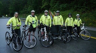 Group of volunteer bicyclists with their bikes